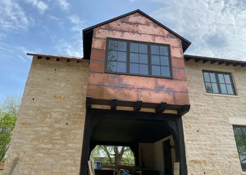Copper metal panel facade on a stone building for Roof Repair in Sanibel