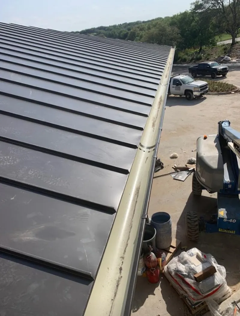 Standing seam panel and gutter detail on a metal roofing jobsite in Sanibel